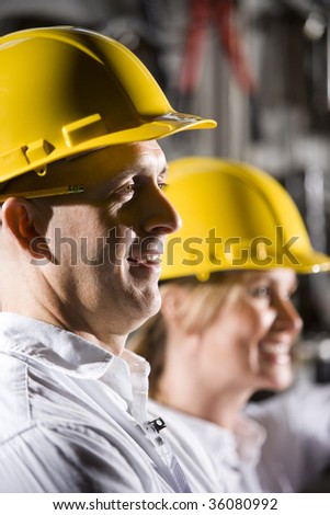 Close up of man and woman wearing hard hats