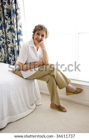 Senior woman relaxing in her bedroom