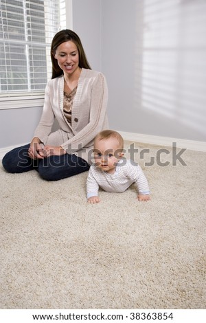 Mother with six month old baby at home