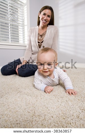 Mother with baby learning to crawl