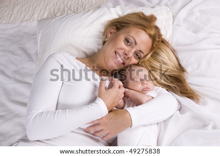 Mother holding one month old baby boy in her arms