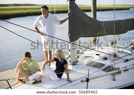 Family vacation together on sailboat on sunny day, on Florida intracoastal waterway