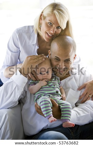 Loving parents with 3 month old baby in dad\'s arms