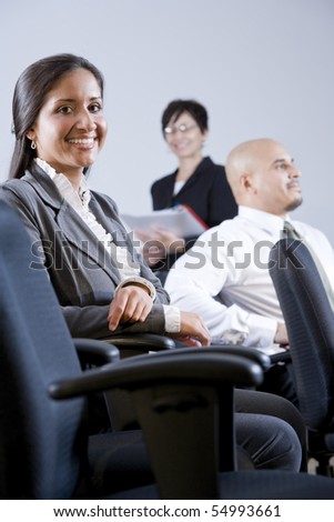 Young adult Hispanic university students or business people watching presentation