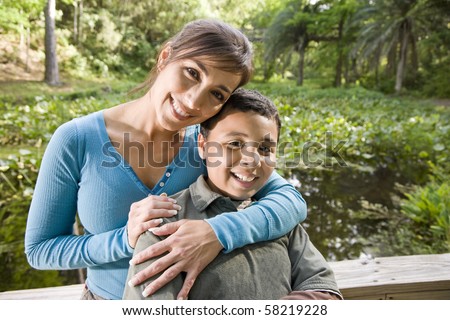Portrait of Hispanic mother and 10 year old son outdoors in park