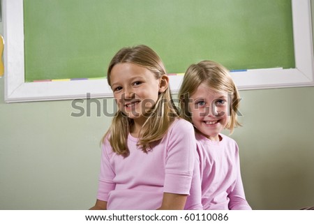 Back to school - two 8 year old girls in classroom