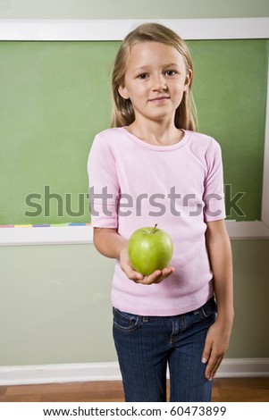 Back to school - 8 year old girl with apple for teacher