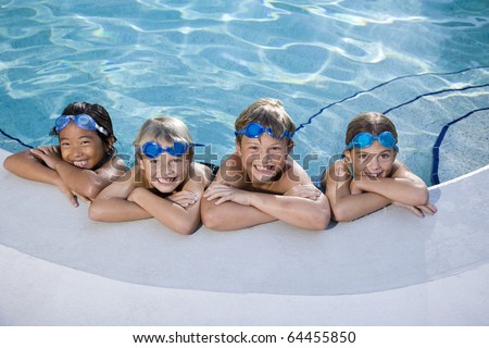 Multi-ethnic kids, relaxing in a row on side of swimming pool, ages 7 to 9