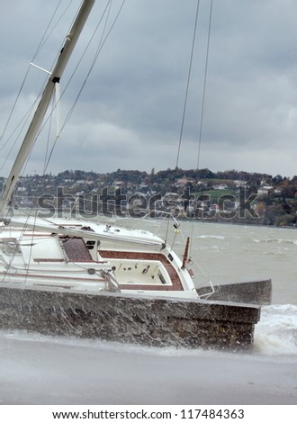 Ran aground boat during big storm by cloudy and rainy day in Geneva, Switzerland