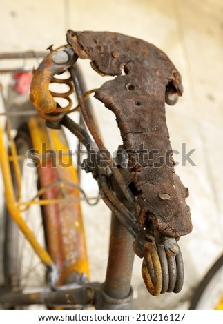 Close up on saddle of burnt bicycle in the street