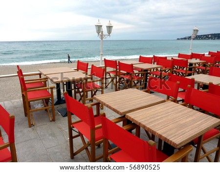 Comment réussir à se faire accepter chez Istock ? Stock-photo-terrace-made-of-red-chairs-black-tables-and-old-looking-lamps-near-the-beach-and-the-mediterranean-56890525