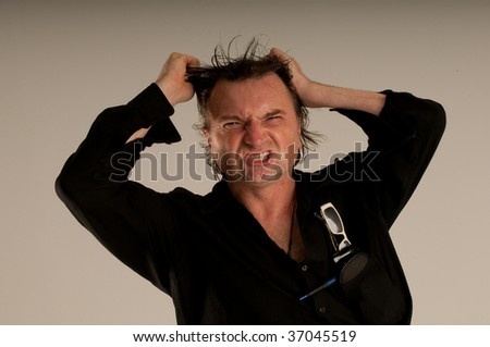 A man Trying to show his anger throw his face expressions