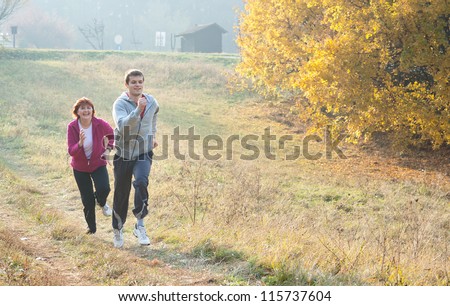 Mom and son jogging in a meadow