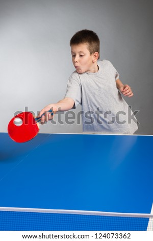 Little Boy playing table tennis