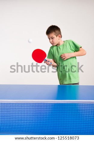 Little Boy playing table tennis