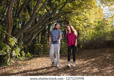 pair walking trough woods