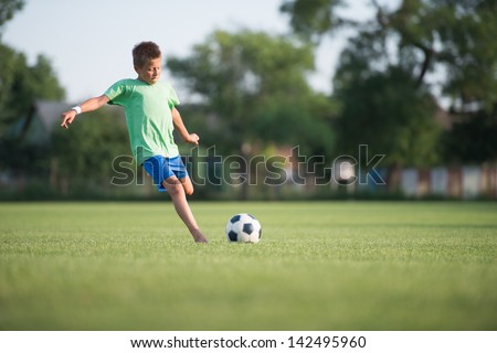 Little Boy Shooting At Goal