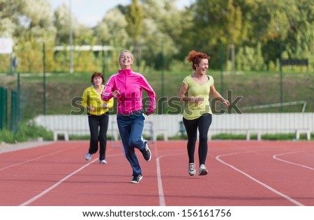 women\'s jogging on athletics track