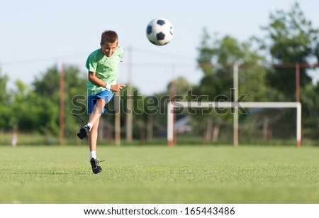 Little Boy Shooting at Goal