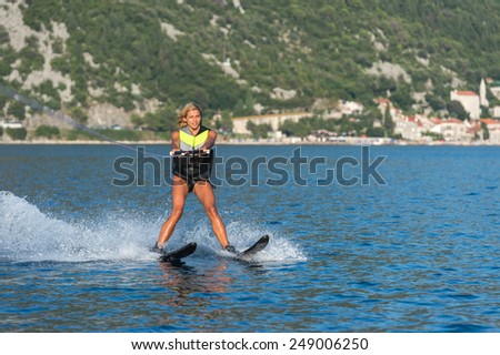 a young woman water skiing on a sea