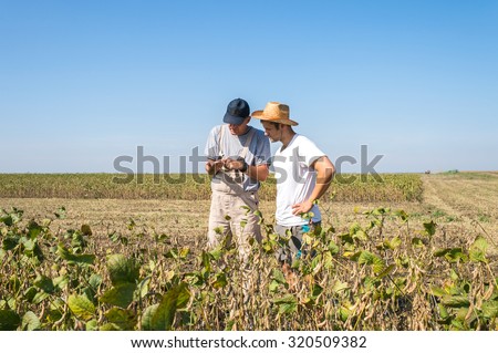 Young farmers in soybean fields