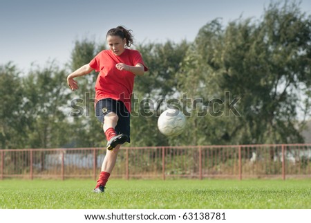 women kicking  ball