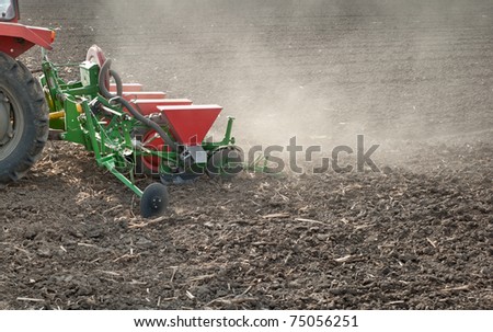farm tractor and seeder planting crops on a field