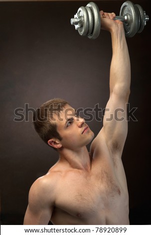 young man  with  weights in hands training