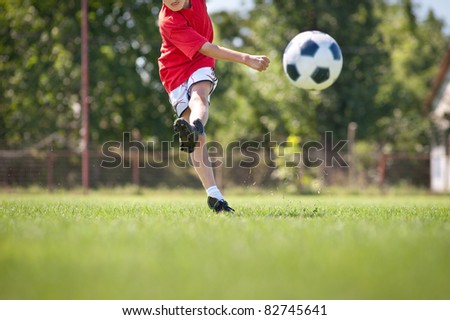 Little Boy Shooting at Goal