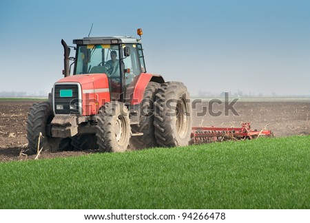 Tractor plowing the fields in spring