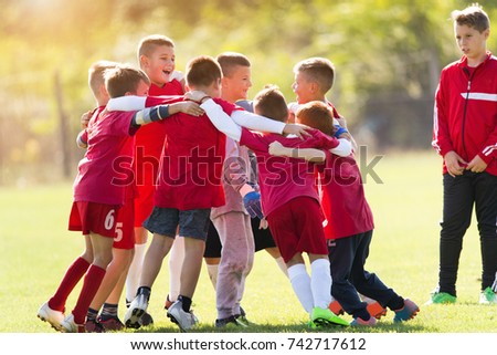 Kids soccer football team in huddle