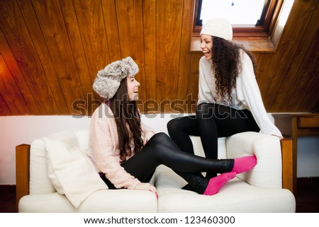 Two friends at home in a cozy attic