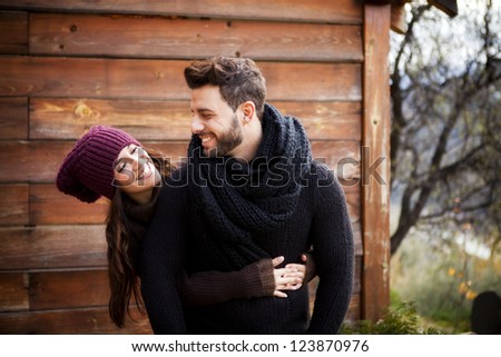 Young cheerful couple in a cabin in a romantic scape.