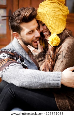 Playful couple in a cabin in romantic scape in winter