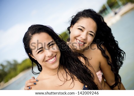 Close portraits of two sisters enjoying in the Caribbean