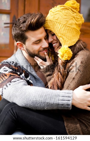 Young couple in a cabin in romantic scape in winter