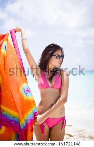 Beautiful girl with a hippie style tissue at a tropical beach.