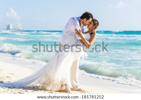 Newlyweds sharing a romantic moment at the beach