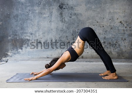 Young woman practicing yoga in a urban background
