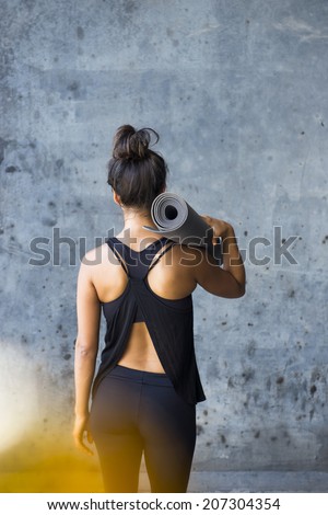 Woman ready to practice yoga in a urban enviromment Woman ready to practice yoga in a urban enviromment