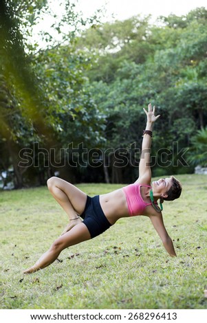 Woman practicing yoga outdoors - side plank pose,vasisthasana