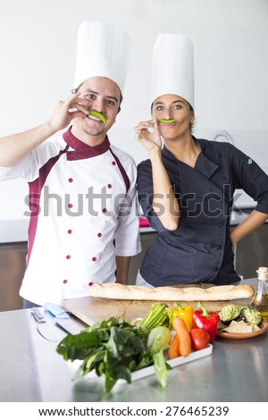 Two latin chefs posing in a cooking school