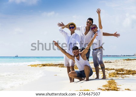 Group of male friends on holidays at the beach