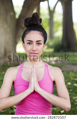 Young yoga teacher practicing outdoors in a park in Barcelona