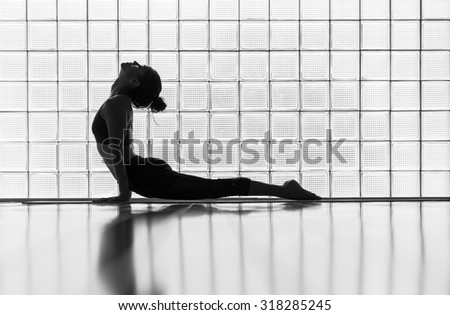 Young woman practicing in a yoga studio. Upward facing dog during sun salutations.