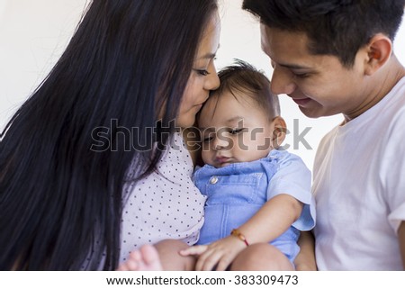 Young mexican family expressing love