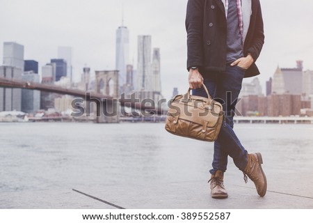 Young handsome man wearing a fashionable outfit in the city