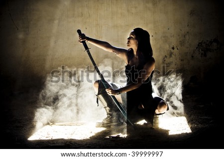 Beautiful woman posing with katana 