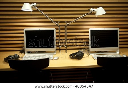 Double office desk with computer and reading lamp