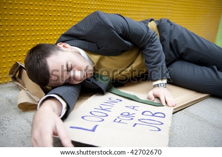 Businessman portrait lying on street with \